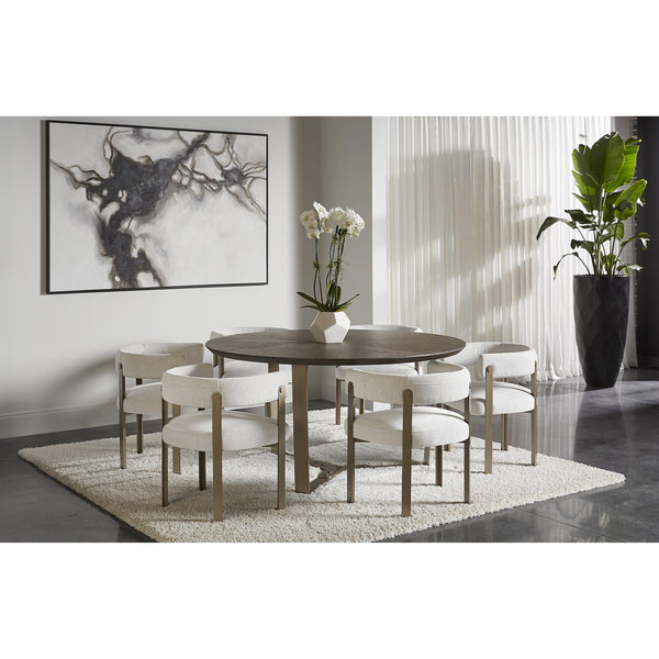 Dining room with a round wooden table and white chairs, featuring a large abstract painting on the wall.