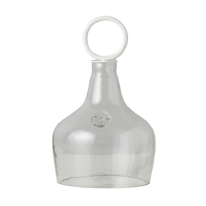 Clear glass food cover with a white ring handle on a white background