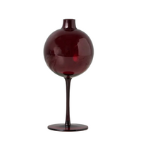 Dark red glass vase on a white background