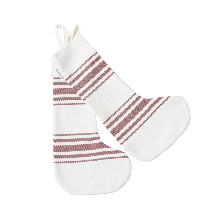White Christmas stocking with red stripes on a white marble background