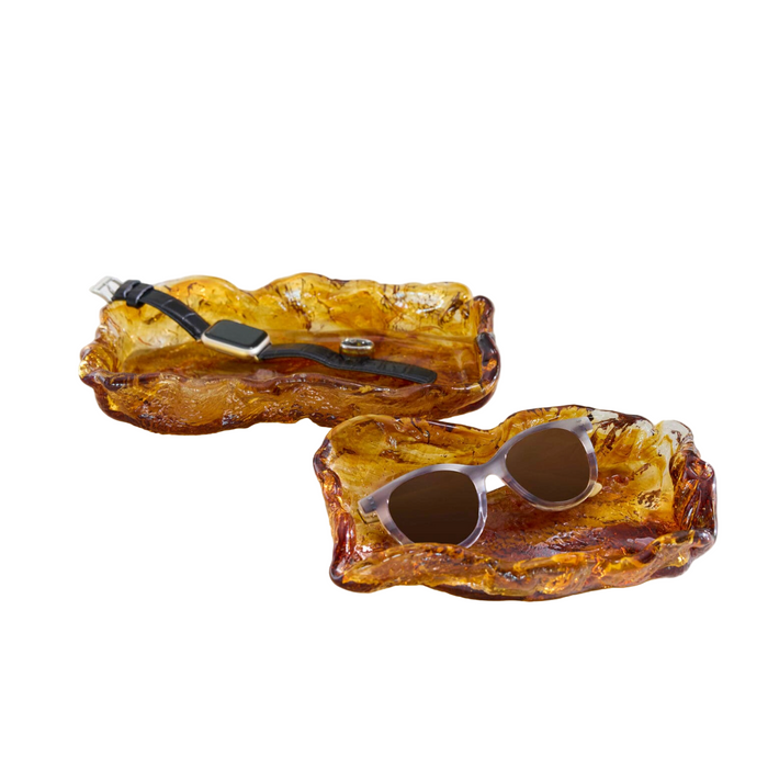 Ambered colored glass bowls with accessories placed inside