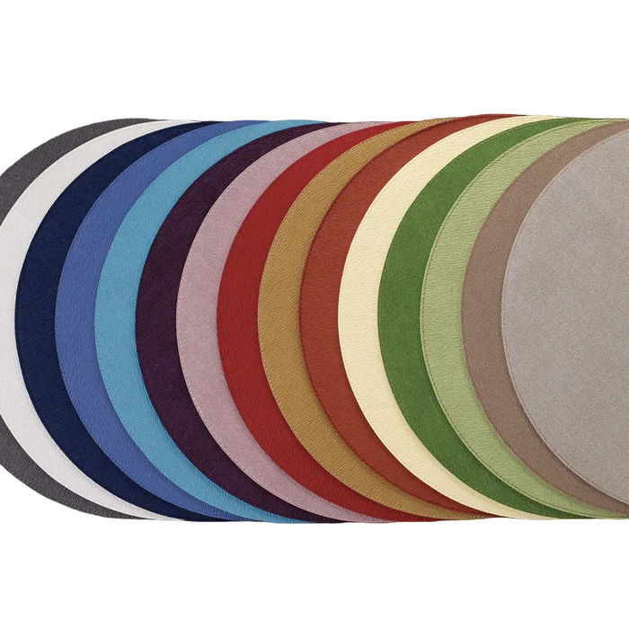 Row of round placemats in various vibrant colors on a white background