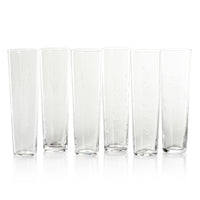 Set of six clear glass tumblers on a white background