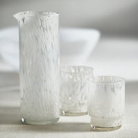 Set of glassware with a white tortoise design on a neutral background