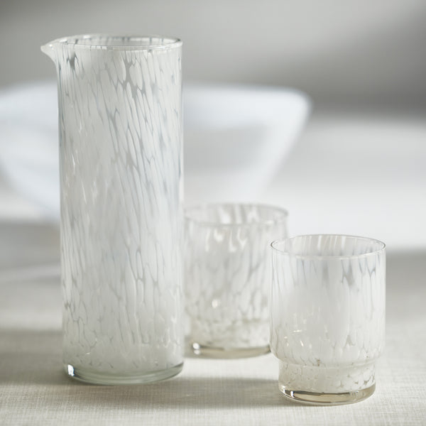 Set of glassware with a white tortoise design on a neutral background
